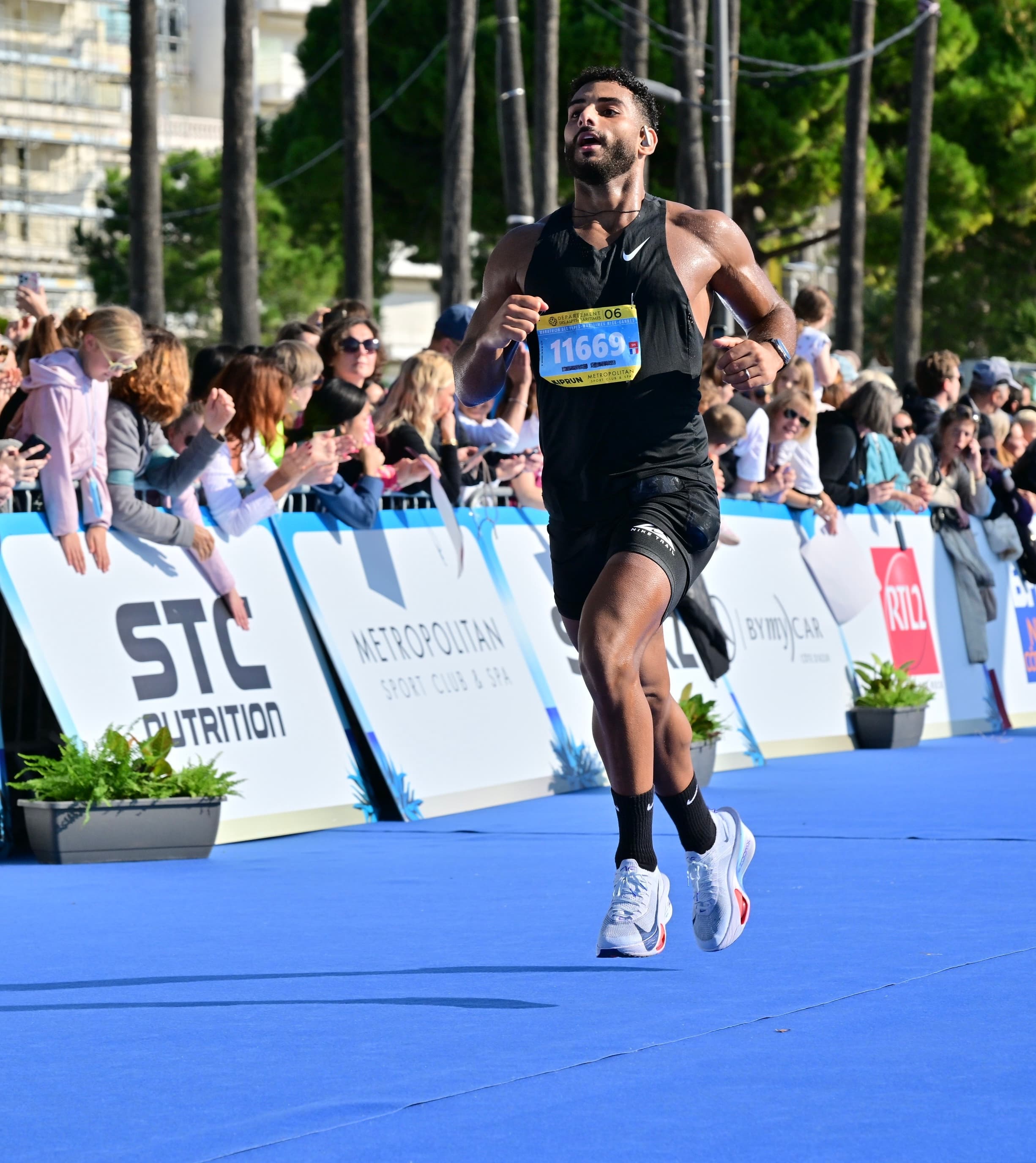 Ahmed crossing the marathon finish line in 2h57